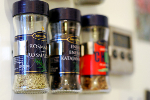 Spices hung on the kitchen cupboard.
