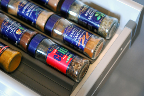 A kitchen drawer full of spices. 